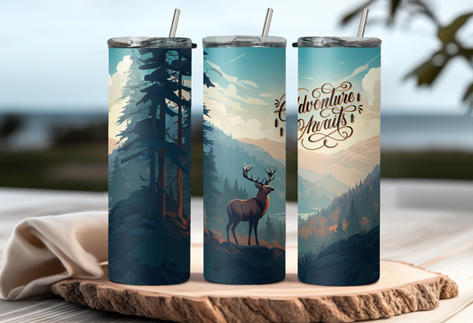 Three insulated tumblers with nature-themed designs on a wooden surface.