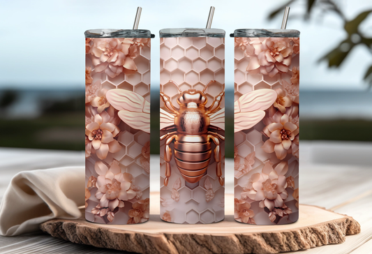 Three tumblers with a rose gold themed bee and floral 3D design on a wooden surface.